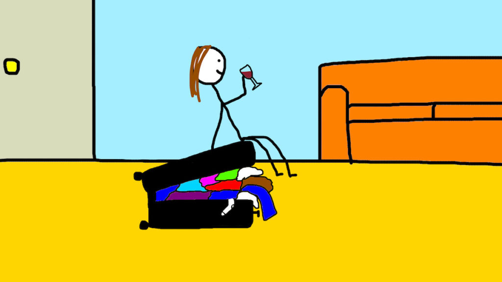 Chrissy sitting on overflowing suitcase with glass of wine